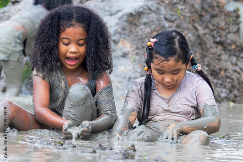 Asian children having fun playing in the mud in the fields on a cloudy day. Asian children wade through water and dirty mud.
Children's outdoor play and learning outside the classroom