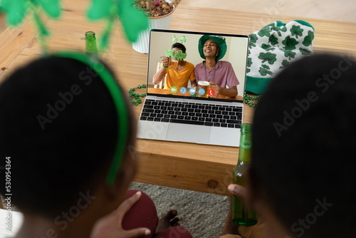 Rear view of african american couple having a video call on laptop at home