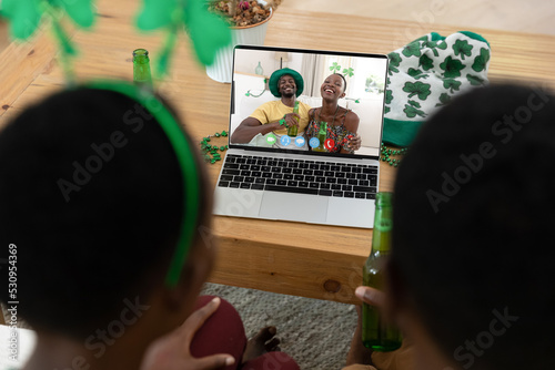 Rear view of african american couple having a video call on laptop at home