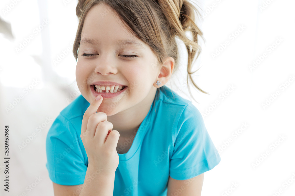 The child has lost a tooth. Little girl without a tooth. The first tooth fell out. High quality photo The child has lost a tooth. Little girl without a tooth. The first tooth fell out. High quality photo