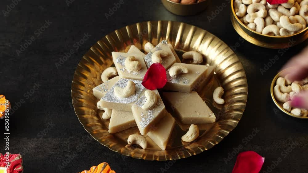 Kaju Katli Kaju Barfi Burfi cashew fudge candy woman hand serving ...