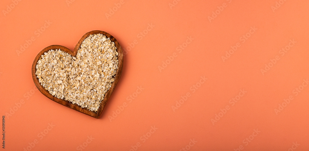 Oat flakes in the heart shaped bowl - Avena sativa