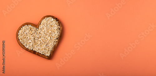 Oat flakes in the heart shaped bowl - Avena sativa