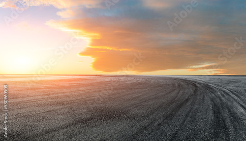 Empty asphalt race track road with beautiful sky clouds at sunrise © ABCDstock