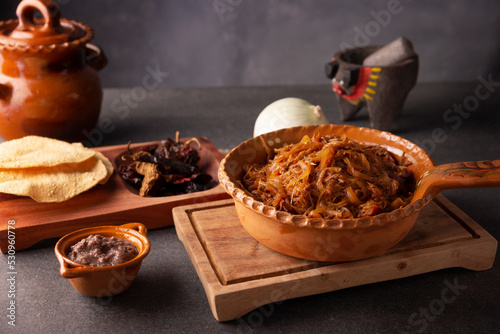 Tinga de Res. Typical Mexican dish prepared mainly with shredded beef, onion and dried chilies. It is customary to serve it on corn tortilla tostadas or tacos.