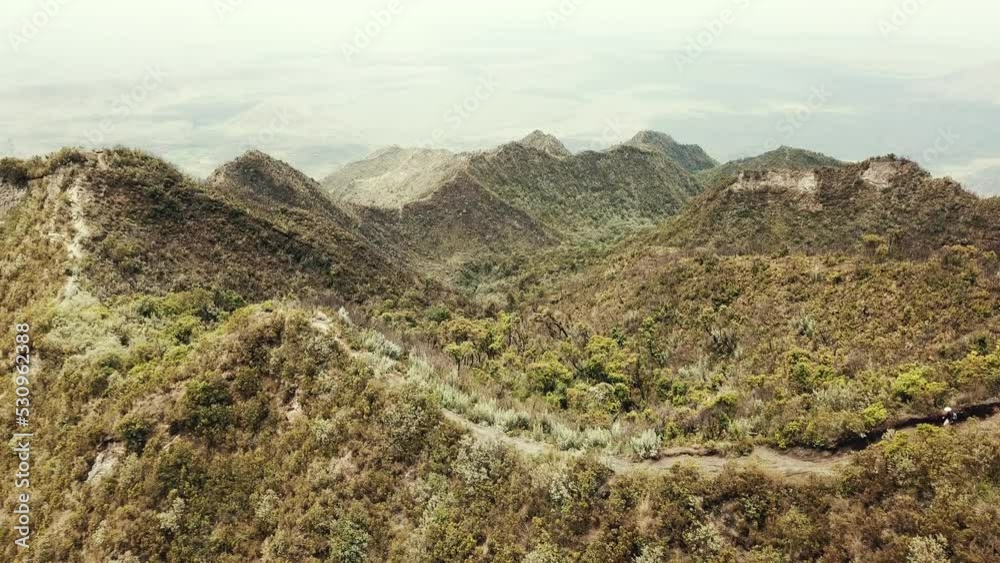 Aerial drone view of hikers walking along the ridge of Mount Longonot, Kenya.