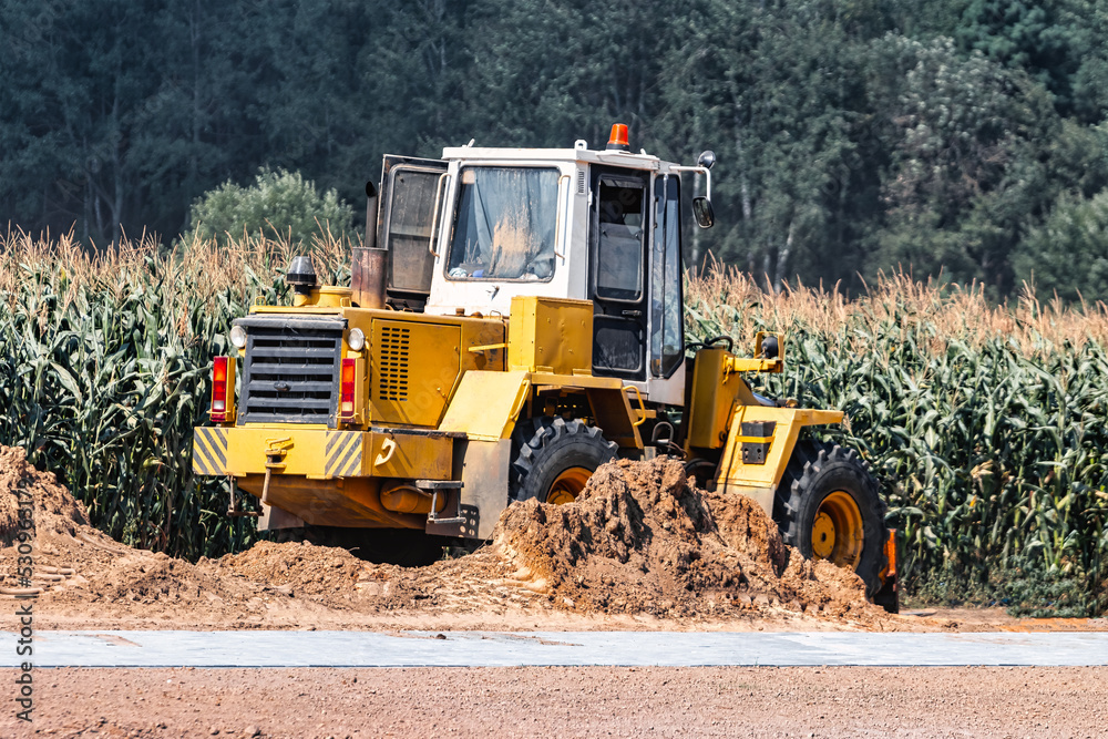 Powerful crawler bulldozer close-up at the construction site. Construction equipment for moving large volumes of soil. Modern construction machine. Road building machine. Powerful crawler bulldozer close-up at the construction site. Construction equipment for moving large volumes of soil. Modern construction machine. Road building machine.