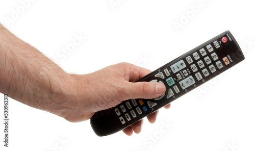 Changing TV program: close up of human hand holding television remote control isolated on white background