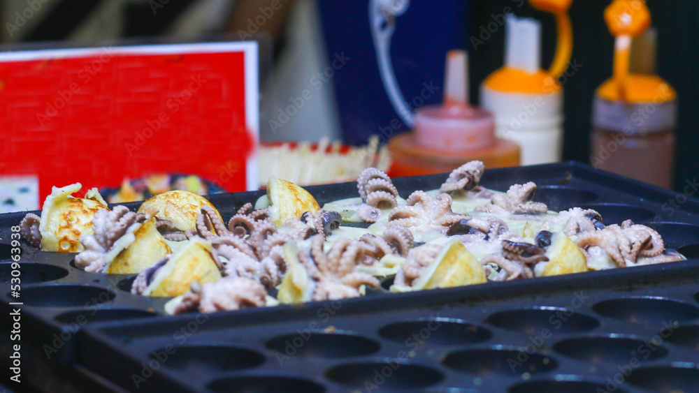 Takoyaki being prepared in Ho Thi Ky street food