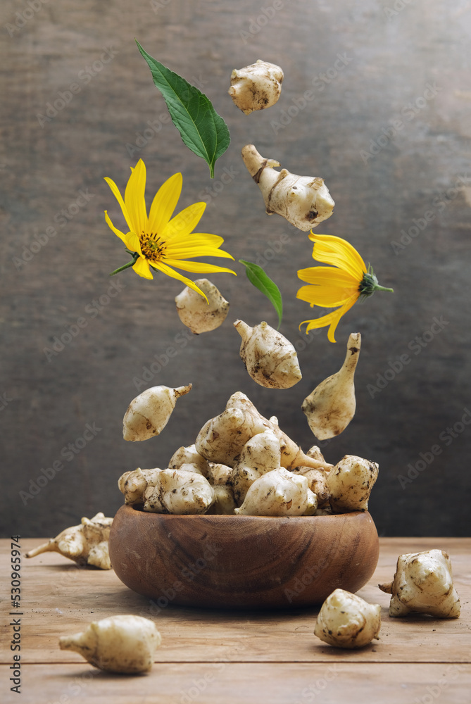 Jerusalem artichoke levitation concept. Roots, flowers and leaves of