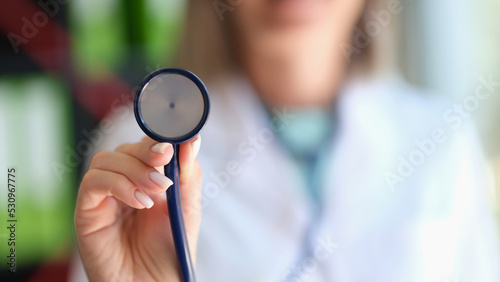 Closeup of cardiologist doctor holding a stethoscope