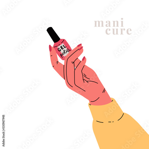 A woman's hand holds nail polish.