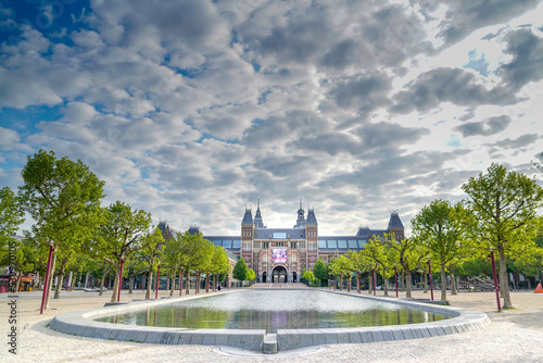 Rijksmuseum with pond and trees under a moody sky, Amsterdam, The Netherlands photo