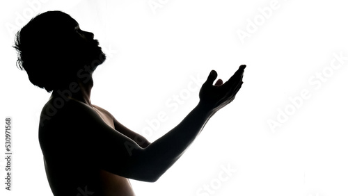 Silhouette of a praying man on a white background. Used in a Thanksgiving project. © STOCK PHOTO 4 U