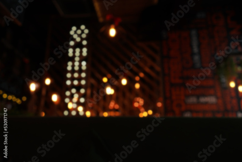 Blur night cafe background with lamp lights.
