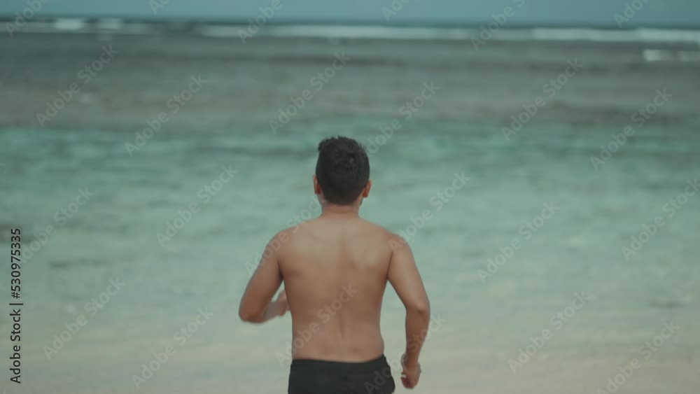 Topless Fit Asian Indonesian Man Running to The Beach Topless Fit Asian Indonesian Man Running to The Beach