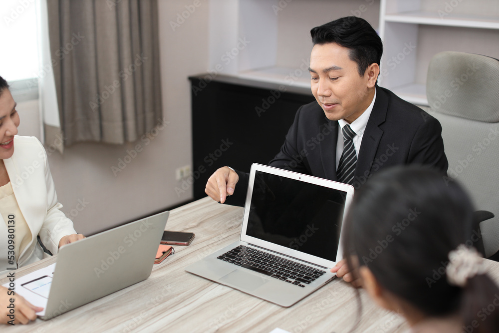 Collaborative process of professional businesspeople going over on new project together, using computer presentation and brainstorming ideas, coworker and working together at office meeting concept Collaborative process of professional businesspeople going over on new project together, using computer presentation and brainstorming ideas, coworker and working together at office meeting concept