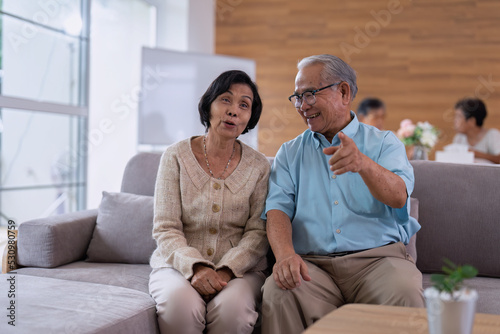 Elder at home care service senior retirement ege pension person sitting on sofar enjoy relaxing watching TV entertainment
