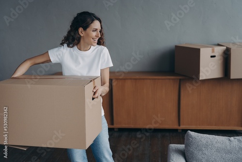 Slika na platnu Female carrying cardboard box to room on moving day