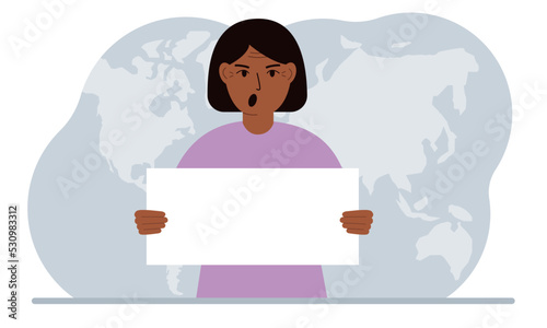 The concept of world attention. A woman holds a white poster in his hands against the background of a world map.