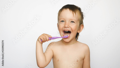 A cute boy has a fun brushing his teeth