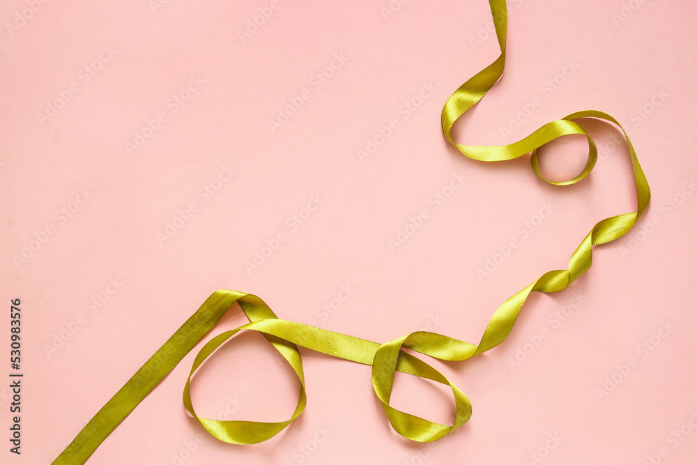 Fototapeta premium Golden ribbon on pink