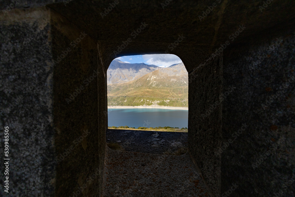 View of Fort Variselle at Lake Montcenis (Moncenisio) on the border between Italy and France. Old ancient historical fort ruins in stone in the Alps mountains