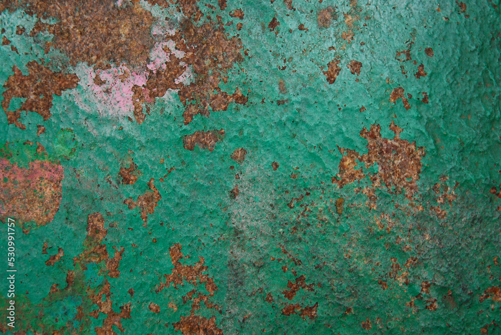 Brown stone painted with paint in pink and green. Rock background, texture. Pattern.