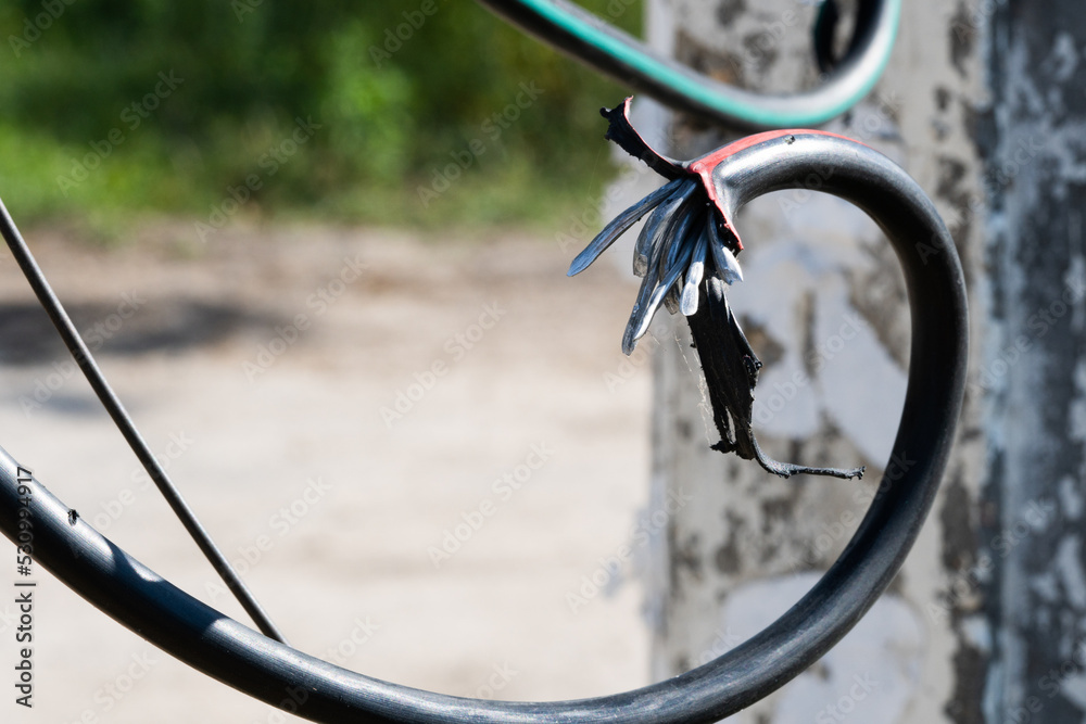 Broken black ground electric cord. Dangerous damage power electrical