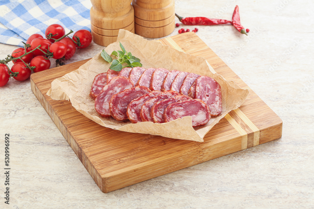 Sliced salami sausages over board Sliced salami sausages over board