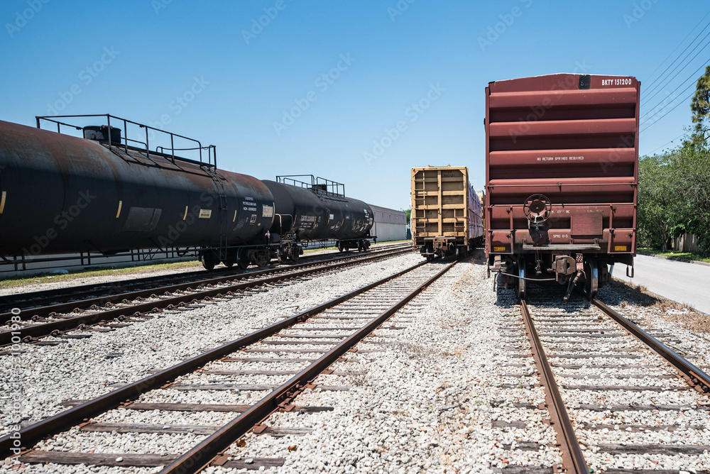 Fototapeta premium Freight rail cars on train tracks