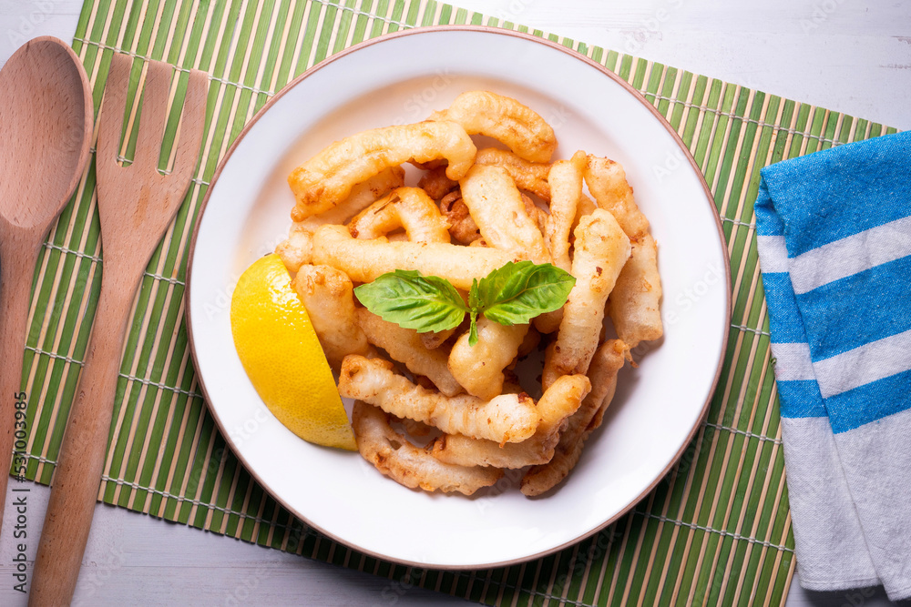 Traditional spanish tapa. Rabas, tasty fried squid with lemon.