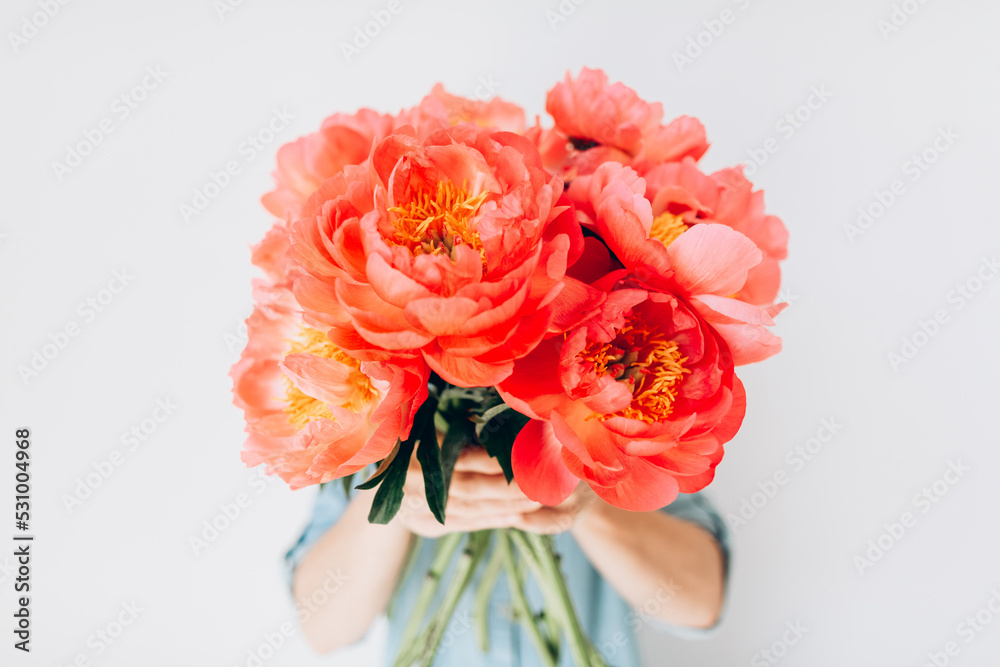 Woman with bouquet of beautiful peonies on white background, close up. Flowers to gift. Spring time and inspiration