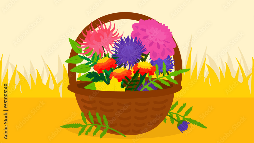 basket with autumn flowers on a background of yellow grass