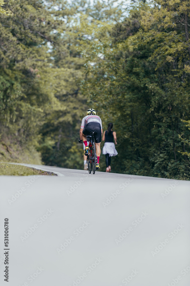 Athletic couple running on a street next to each other. Nature,fit and healthy concept. Athletic couple running on a street next to each other. Nature,fit and healthy concept.