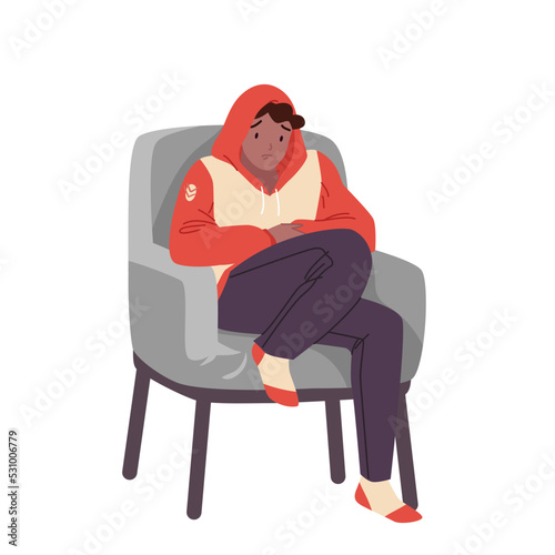 Sad boy in chair is cold in winter or autumn season vector illustration. Cartoon isolated young man in cozy hoodie, woolen socks sitting in home armchair to keep warm, suffering from low temperature