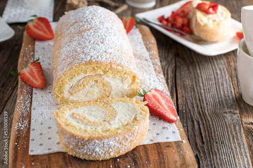 Swiss roll with whipped cream and strawberries