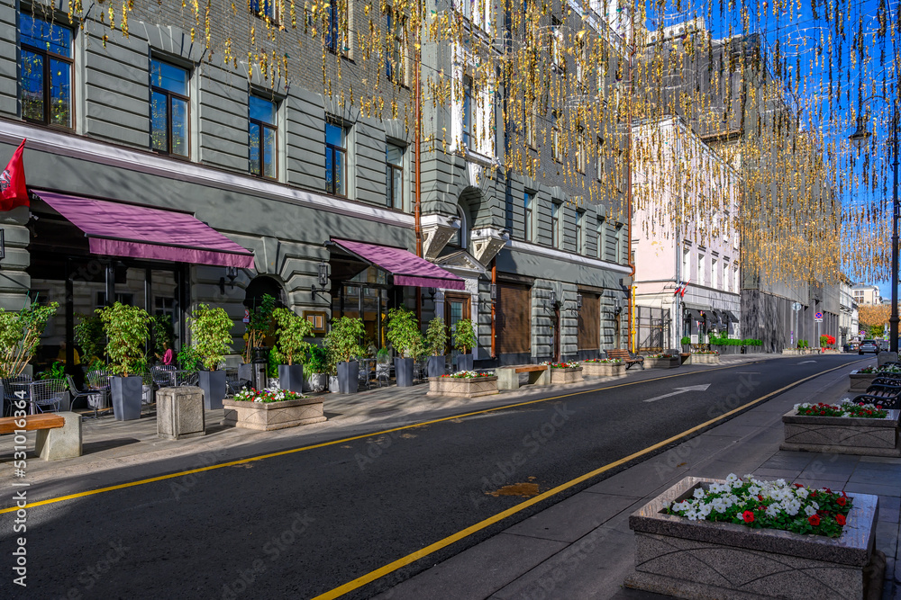 Bolshaya Dmitrovka street with tables of cafe in Moscow, Russia. Moscow architecture and landmark. Moscow cityscape