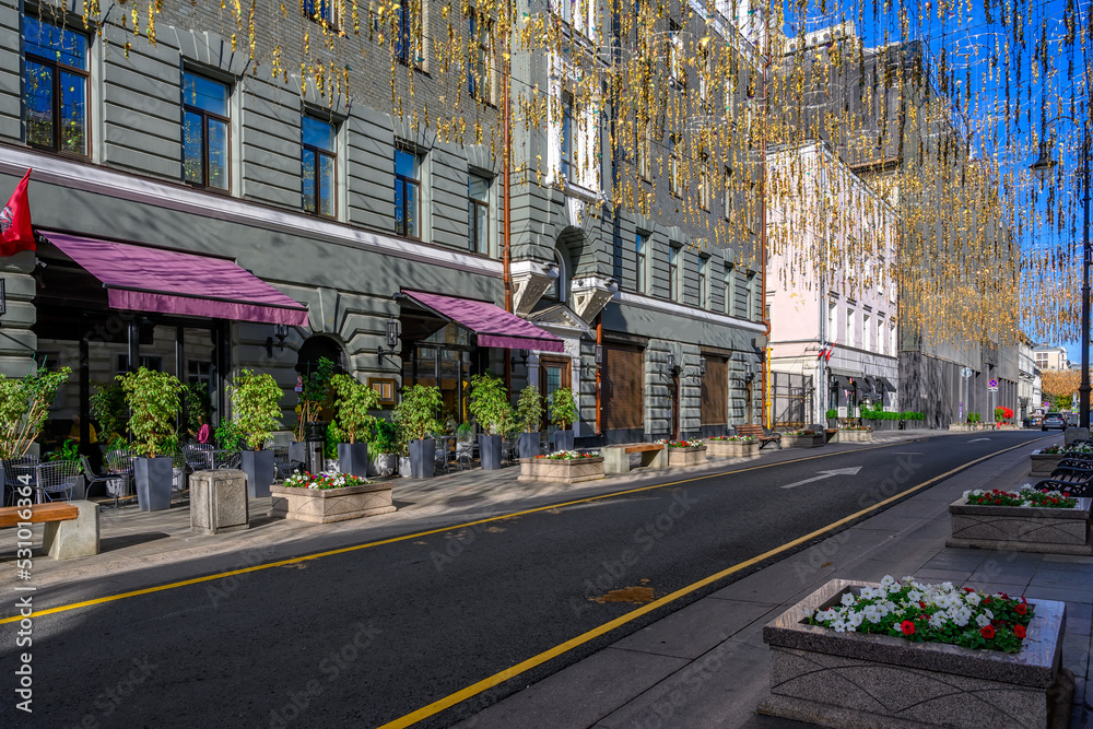 Bolshaya Dmitrovka street with tables of cafe in Moscow, Russia. Moscow architecture and landmark. Moscow cityscape Bolshaya Dmitrovka street with tables of cafe in Moscow, Russia. Moscow architecture and landmark. Moscow cityscape