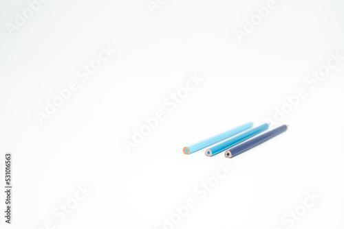 blue wooden colored pencil on a white background with end part in focus