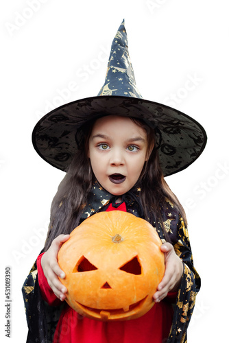 A preschool girl in a witch costume with a pumpkin in her hands. halloween holiday