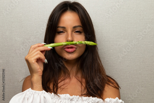Beautiful girl with asparagus. Woman On Diet Nutrition.