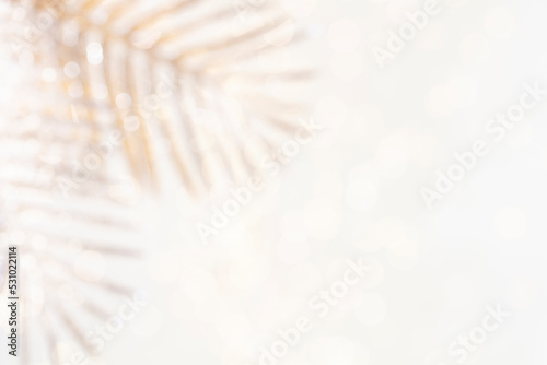 Shiny gradient background with golden palm leaf and bokeh.