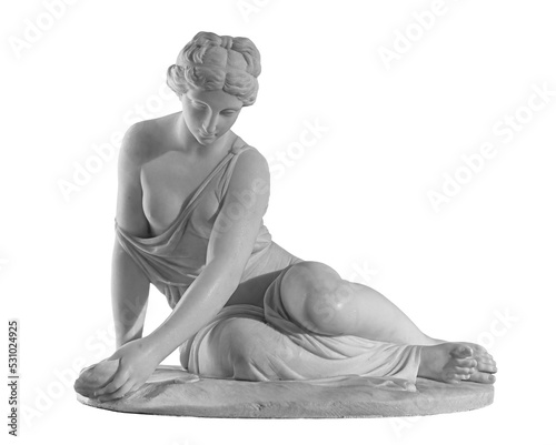 Ancient marble statue of a nude woman. Antique naked female sculpture. Sculpture isolated on white background photo