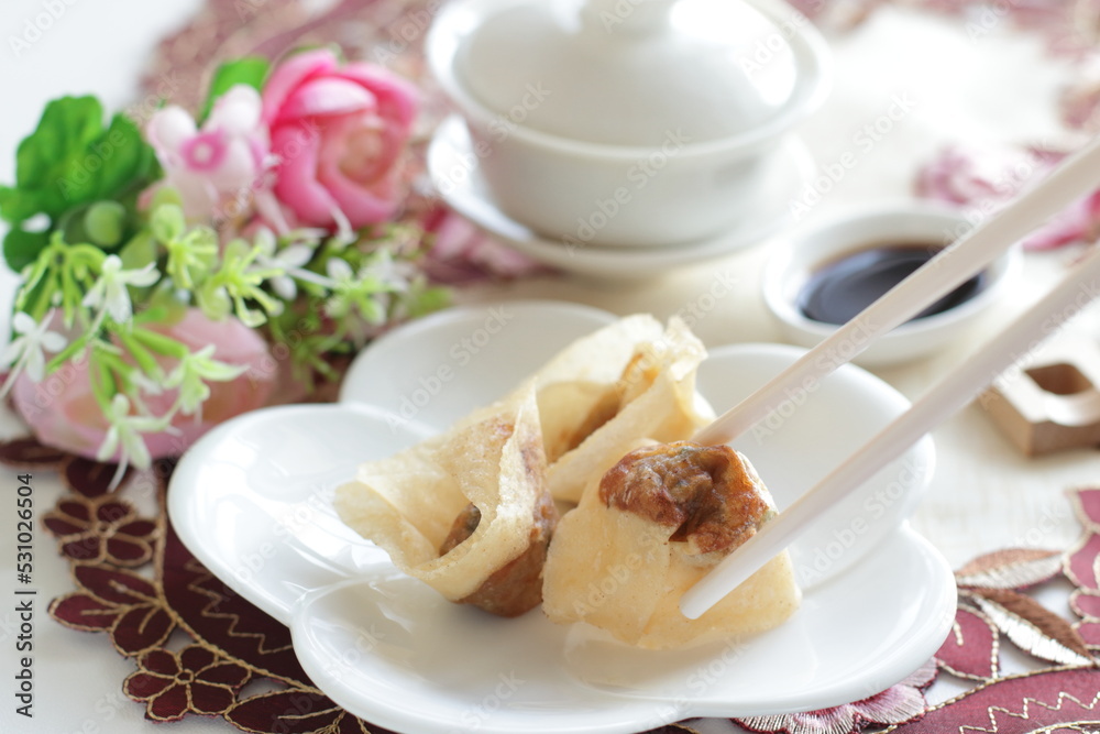 Chinese food, deep fried Wonton dumpling on white dish Chinese food, deep fried Wonton dumpling on white dish