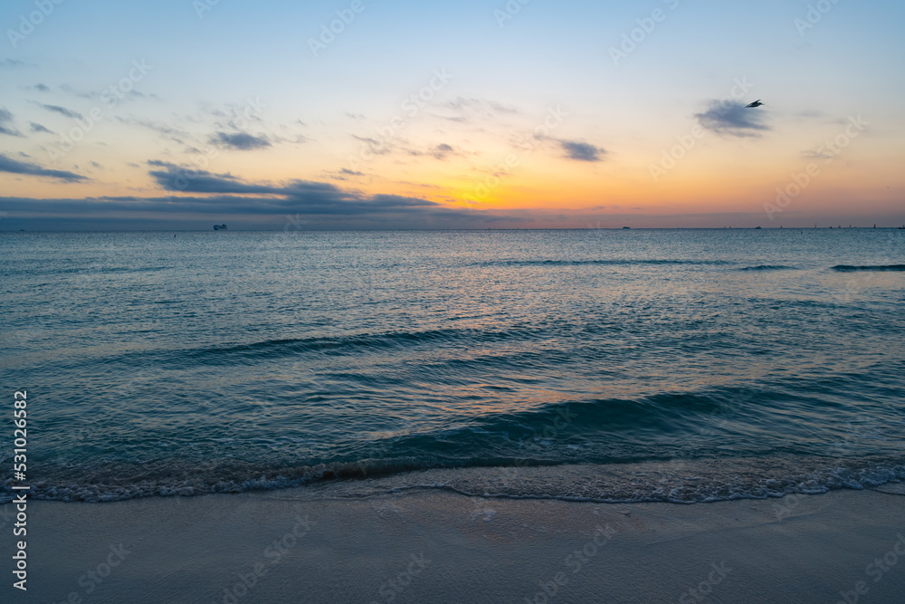 beautiful sunset with ocean water on the summer beach