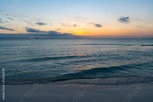 beautiful sunset with ocean water on the summer beach