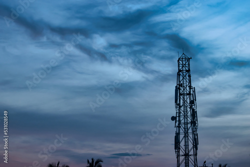 Mobile Telecommunication Radio Tower with Cloudy Sky. Cell Phone Tower.
