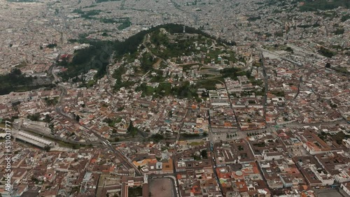 The Crowded City Of Quito With The Famous Statue Of The Virgin of El Panecillo In Ecuador. Aerial Tilt-up