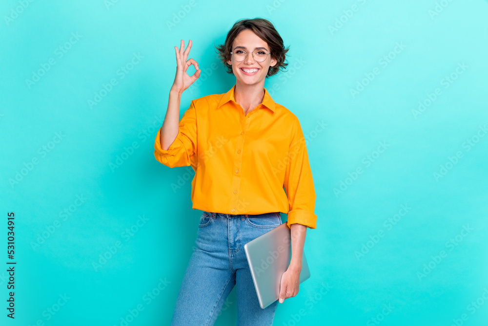 Leinwandbild Motiv - deagreez : Portrait photo of young adorable gorgeous nice woman wear shirt hold computer toothy smile showing okey sign recommend youtube isolated on cyan color background